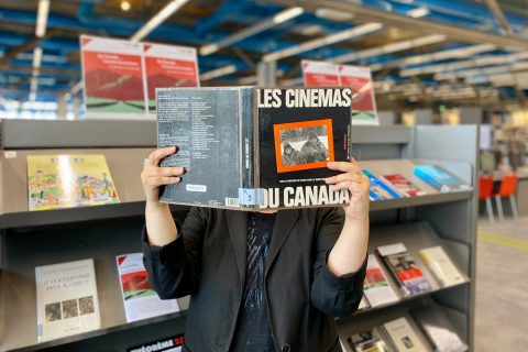 usager consultant un ouvrage dans la bibliothèque